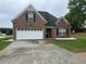 Charming brick home with attached garage and well-maintained lawn at 1266 Laurelwood Ct, Lawrenceville, GA 30045