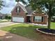 Charming brick home with a two-car garage, landscaping, and inviting curb appeal at 1266 Laurelwood Ct, Lawrenceville, GA 30045