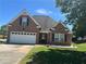 Charming brick home with attached garage and well-maintained lawn on a sunny day at 1266 Laurelwood Ct, Lawrenceville, GA 30045
