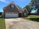 Charming brick home with well-manicured lawn, a two-car garage, and mature trees in a desirable neighborhood at 1266 Laurelwood Ct, Lawrenceville, GA 30045