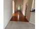 Hallway with transition from carpet to hardwood, guiding towards a well-lit entrance and other areas at 1266 Laurelwood Ct, Lawrenceville, GA 30045