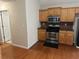 Kitchen featuring wood cabinets, stainless steel appliances, and hardwood flooring at 1266 Laurelwood Ct, Lawrenceville, GA 30045