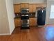 Galley kitchen with stainless steel appliances, brown backsplash, and wooden cabinets at 1266 Laurelwood Ct, Lawrenceville, GA 30045
