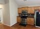 Kitchen featuring wood cabinets, stainless steel appliances, and hardwood flooring at 1266 Laurelwood Ct, Lawrenceville, GA 30045