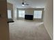 Spacious living room with high ceilings, a fireplace, neutral carpet, and natural light from multiple windows at 1266 Laurelwood Ct, Lawrenceville, GA 30045