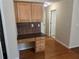 This home office features wood cabinets and drawers for ample storage space, with dark countertops and backsplash at 1266 Laurelwood Ct, Lawrenceville, GA 30045