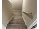 Staircase with plush carpeting and a secure handrail, ensuring safe and comfortable movement between floors at 1266 Laurelwood Ct, Lawrenceville, GA 30045