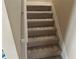 Carpeted stairs with white trim and handrail, providing a safe and comfortable transition between levels at 1266 Laurelwood Ct, Lawrenceville, GA 30045
