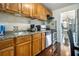 Functional kitchen with wood cabinets, granite countertops, stainless steel appliances, and an open layout to the dining area at 215 Piedmont Ne Ave # 507, Atlanta, GA 30308