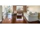 Cozy living room featuring hardwood floors, neutral decor, large window with city views, and comfortable seating at 215 Piedmont Ne Ave # 507, Atlanta, GA 30308