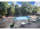 Community pool with ample seating and lush landscaping at 215 Piedmont Ne Ave # 507, Atlanta, GA 30308
