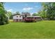 View of house from backyard featuring a large grass lawn and exterior features at 2255 Chippewa Dr, Riverdale, GA 30296