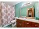 Cozy bathroom featuring a toilet, vanity with sink, and a shower with a patterned curtain at 2255 Chippewa Dr, Riverdale, GA 30296