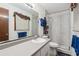 The bathroom features a white vanity, tile shower and a window with lots of natural light at 2255 Chippewa Dr, Riverdale, GA 30296