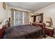 Traditional bedroom featuring carpet, dark wood furnishings and floral curtains at 2255 Chippewa Dr, Riverdale, GA 30296