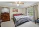 Bedroom with carpet, window and wood furnishings and a blue and red bedspread at 2255 Chippewa Dr, Riverdale, GA 30296