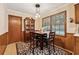 Eat-in kitchen dining area with square table, wood floors, a patterned rug and natural light from the window at 2255 Chippewa Dr, Riverdale, GA 30296