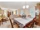 Elegant dining room with a large table, decorative cabinet, and stylish lighting at 2255 Chippewa Dr, Riverdale, GA 30296