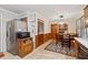 View of the kitchen area, including dining table, refrigerator and wood-look paneled wall at 2255 Chippewa Dr, Riverdale, GA 30296