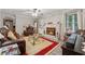Cozy living room with a fireplace, plush seating, and bright lighting fixtures at 2255 Chippewa Dr, Riverdale, GA 30296