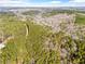 Aerial view of wooded property with a road running through it at 500 Nolan Rd, Carrollton, GA 30116