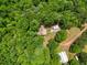 Aerial view of home surrounded by trees and outbuilding at 500 Nolan Rd, Carrollton, GA 30116