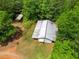 Aerial view of outbuilding and yard surrounded by trees at 500 Nolan Rd, Carrollton, GA 30116