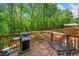 Outdoor deck featuring a grill and dining area is perfect for entertaining in a natural setting at 500 Nolan Rd, Carrollton, GA 30116
