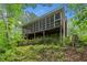 Spacious screened-in porch offers an ideal outdoor space with views of the surrounding trees at 500 Nolan Rd, Carrollton, GA 30116