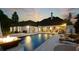 Back of house with pool and outdoor seating, overlooking a backyard at dusk with a firepit at , Buford, GA 30518