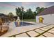 Back of house with pool and outdoor seating and fireplace, overlooking a backyard at , Buford, GA 30518
