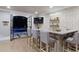 Basement wet bar with marble counter, herringbone backsplash, and seating for four at , Buford, GA 30518