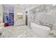 Luxurious bathroom with marble floors, walk-in shower, and freestanding tub at , Buford, GA 30518