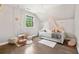Stylish bedroom featuring a daybed with canopy, a hanging swing, hardwood floors and a window at , Buford, GA 30518