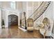 This light foyer features a staircase with decorative railings, light wood floors, and decorative seating at , Buford, GA 30518