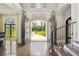 Grand foyer with a view of the backyard, showcasing elegant staircase and gorgeous wood floors at , Buford, GA 30518