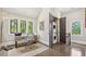Bright home office with desk, chair, lots of windows and stacked washer/dryer in closet at , Buford, GA 30518