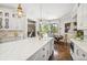 Spacious kitchen with white cabinets, marble countertops, custom lighting, and stainless steel appliances at , Buford, GA 30518