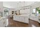 Bright kitchen boasts custom white cabinets, stainless appliances, and a central island with stone countertops at , Buford, GA 30518