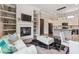 Bright living room open to a kitchen, a fireplace with decorative shelves, and large windows at , Buford, GA 30518