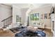 Open floor plan showcases a modern living room with stair case, fireplace and dining area at , Buford, GA 30518