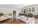 Bright office with a chaise lounge, wooden desk, hardwood floors and natural light at , Buford, GA 30518