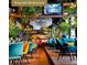 Restaurant interior with plants, modern chandelier, and comfortable seating at , Buford, GA 30518