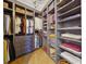 Spacious walk-in closet with custom shelving, drawers and hanging storage for clothing and accessories at , Buford, GA 30518