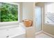 Bathroom featuring a soaking tub, glass shower, and a view of the outdoors at 138 Knightwood Pt, Acworth, GA 30101
