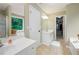 Bright bathroom with dual vanities, a walk-in closet, and a tub at 138 Knightwood Pt, Acworth, GA 30101