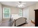 Bright bedroom with ample natural light, neutral color scheme, ceiling fan and comfortable sleeping space at 138 Knightwood Pt, Acworth, GA 30101