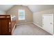 Neutral bedroom with a crib and closet, well-lit by a window, featuring carpet flooring at 138 Knightwood Pt, Acworth, GA 30101