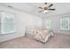 Bright bedroom with large windows, neutral carpet, and ceiling fan at 138 Knightwood Pt, Acworth, GA 30101
