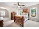 Cozy bedroom featuring a natural wood bed frame, windows with tree views, and neutral walls at 138 Knightwood Pt, Acworth, GA 30101